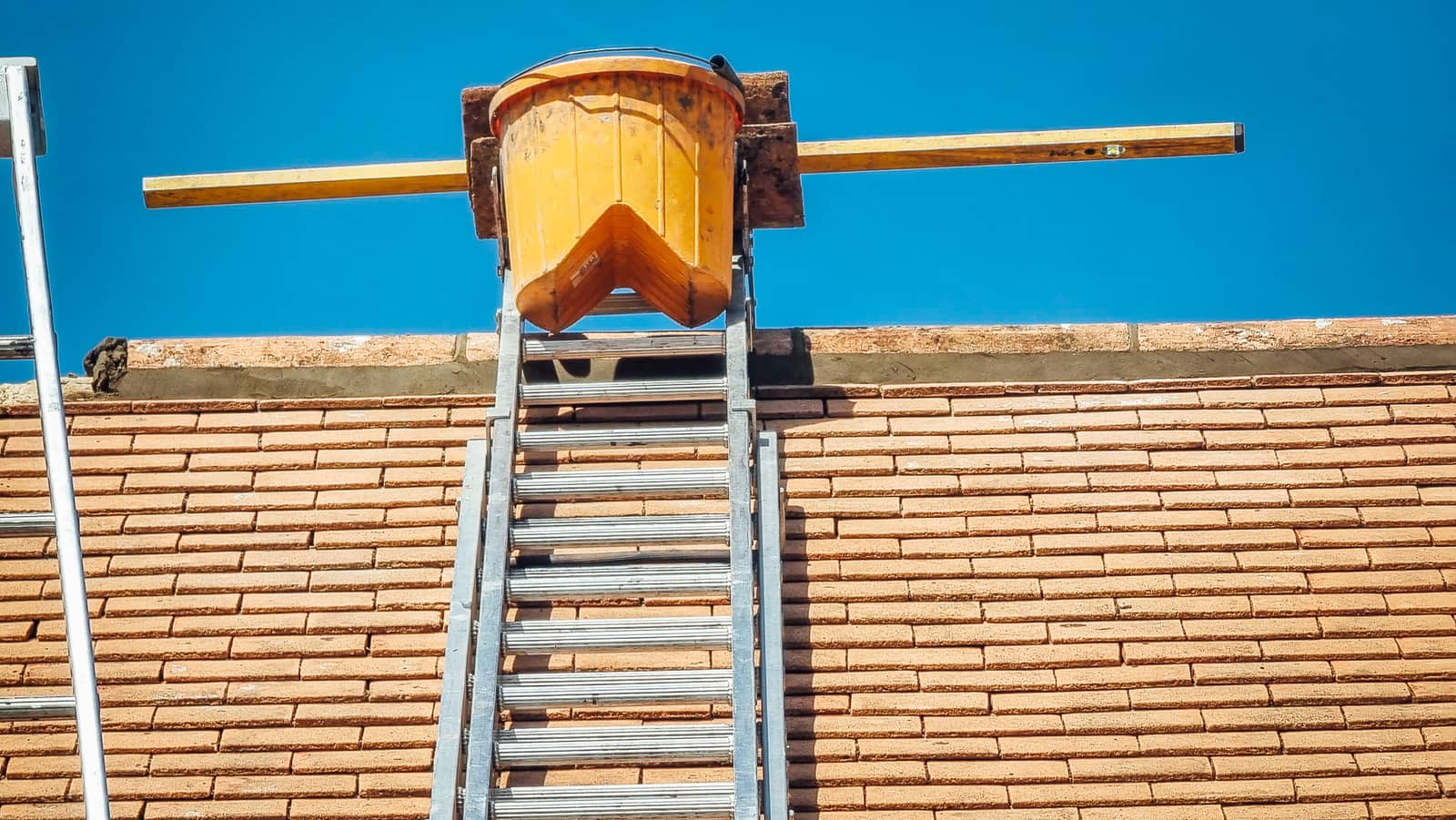 Finished lead soakers and tiles around a soil pipe on a pitched roof