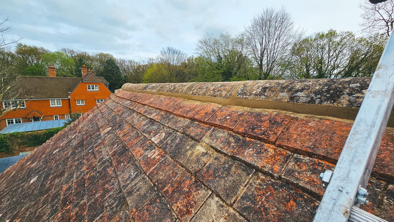 Aerial view of chimney with lead flashing on a brown tiled roof