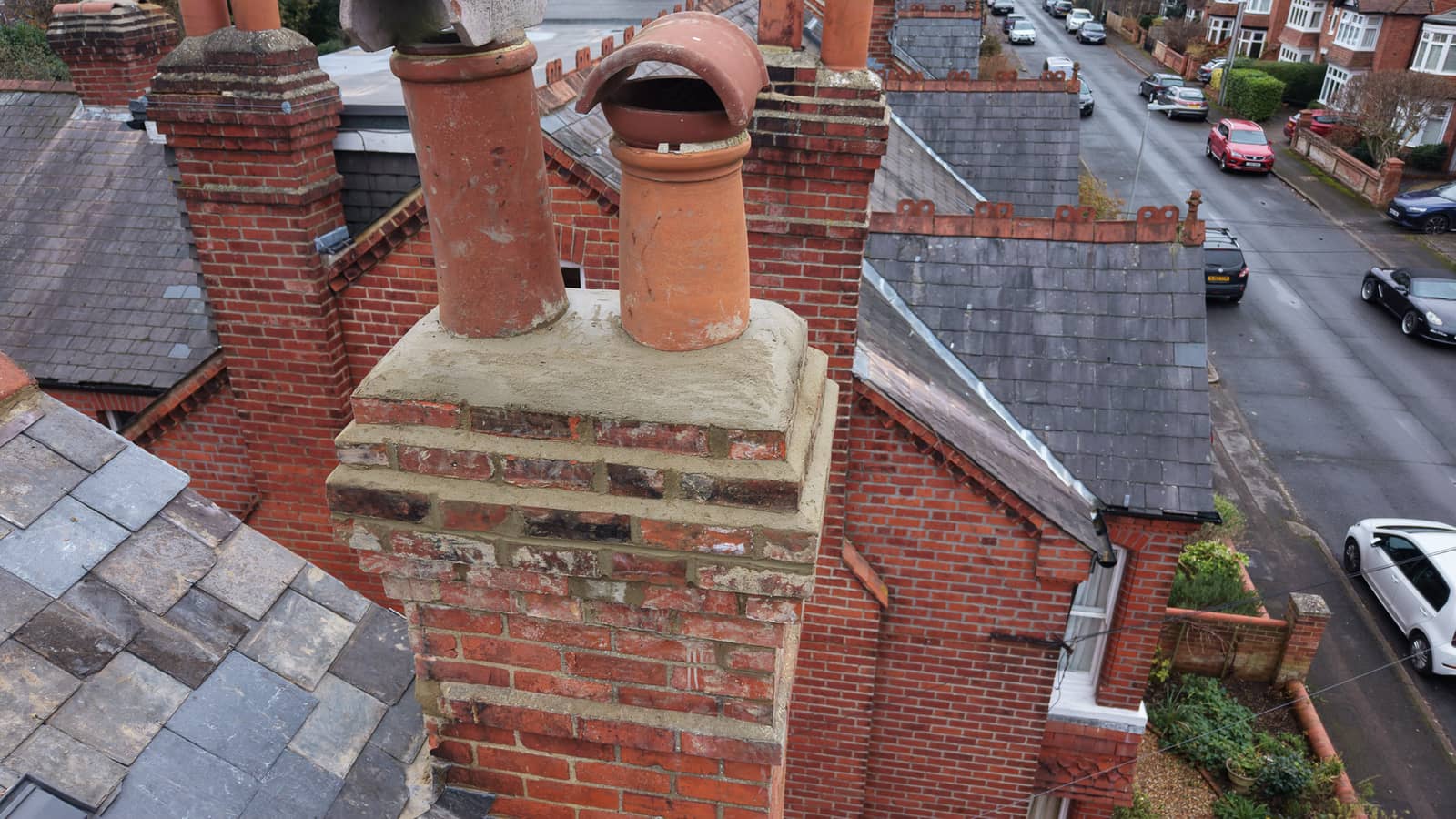 Aerial view of a pitched roof with chimney on a residential property