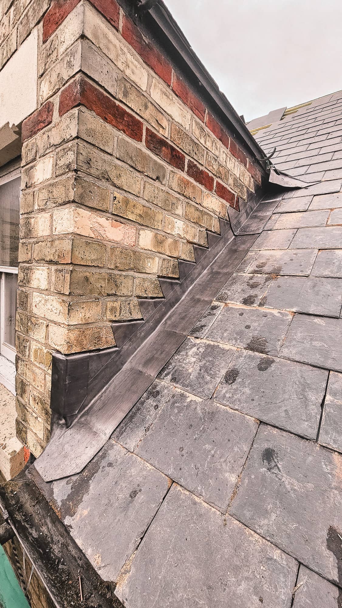 Lead valley flashing between slate roof slopes