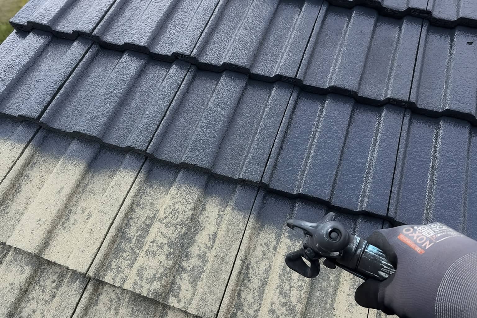 Spray-on pigment coating applied to concrete roofing tiles